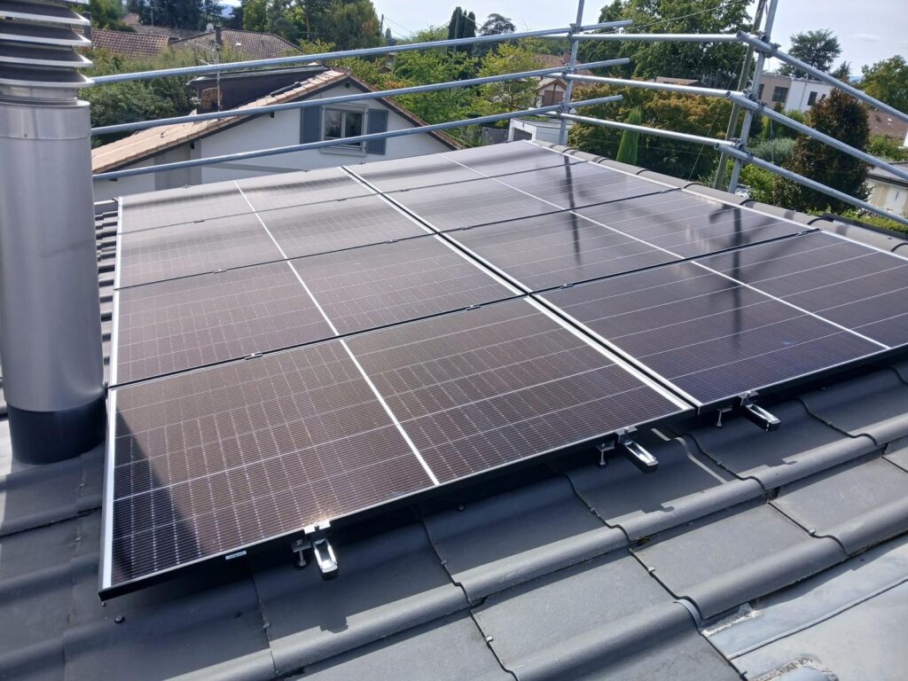 Panneaux solaires fixés sur la toiture en tuiles d’une villa à Vessy